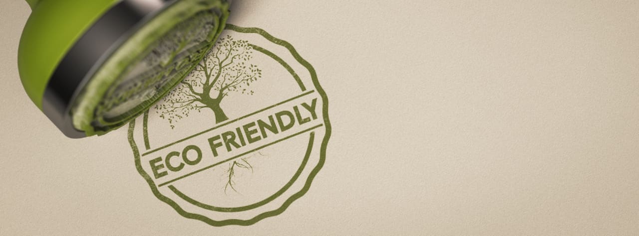 a green eco friendly stamp on a paper in green color with a tree 