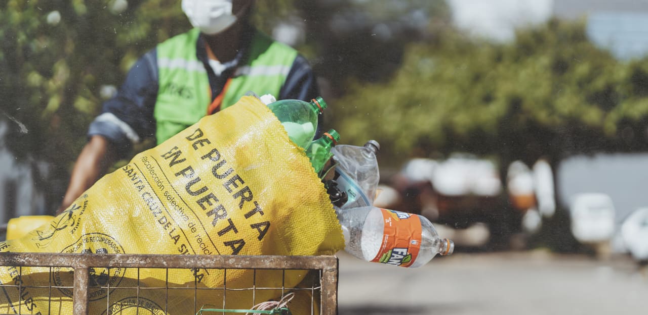 R4S group's Plastic waste pickers with a bag of plastic bottle waste