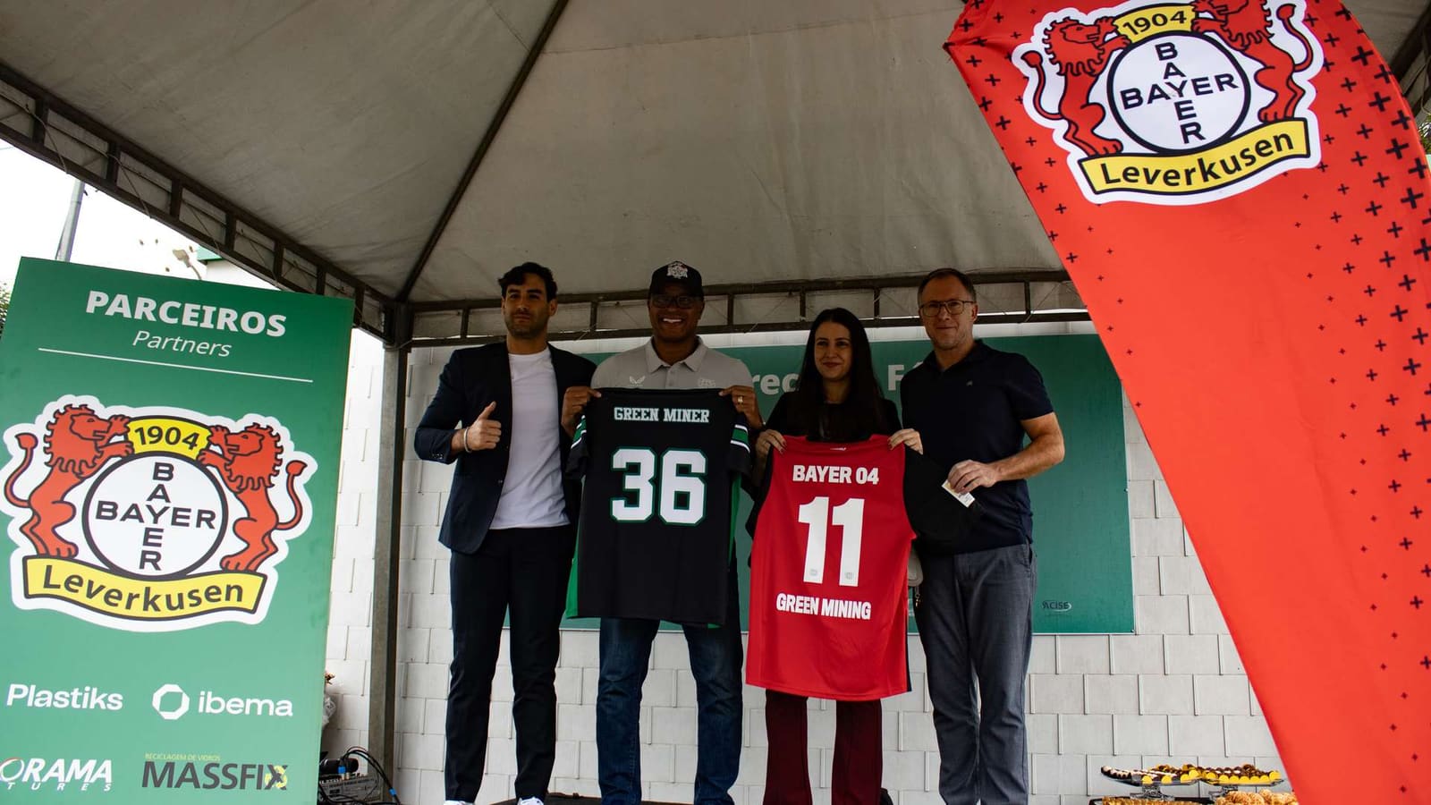 Plastiks partners with Bayer 04 Leverkusen and Green Mining in Brazil to launch a community-focused plastic recovery initiative, featuring team members holding jerseys at the collaboration launch event.