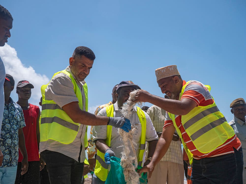 Volunteers sorting through collected plastic waste during the International Coastal Cleanup Day in Mombasa, Kenya, demonstrating the community effort to reduce pollution